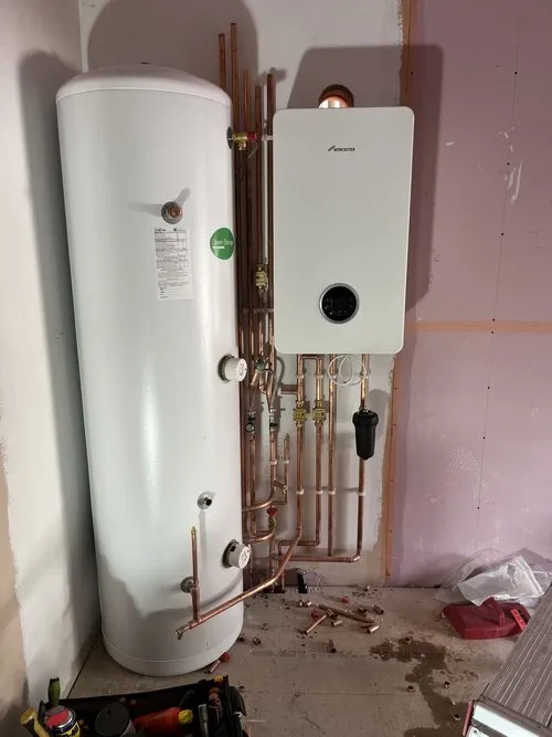Boiler and hot water cylinder installation with copper pipework