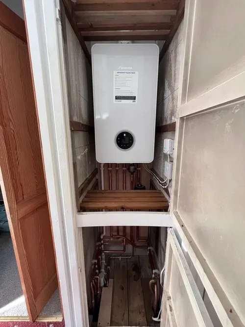 Gas boiler installation in compact cupboard