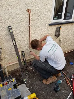 Engineer working on external gas pipe installation